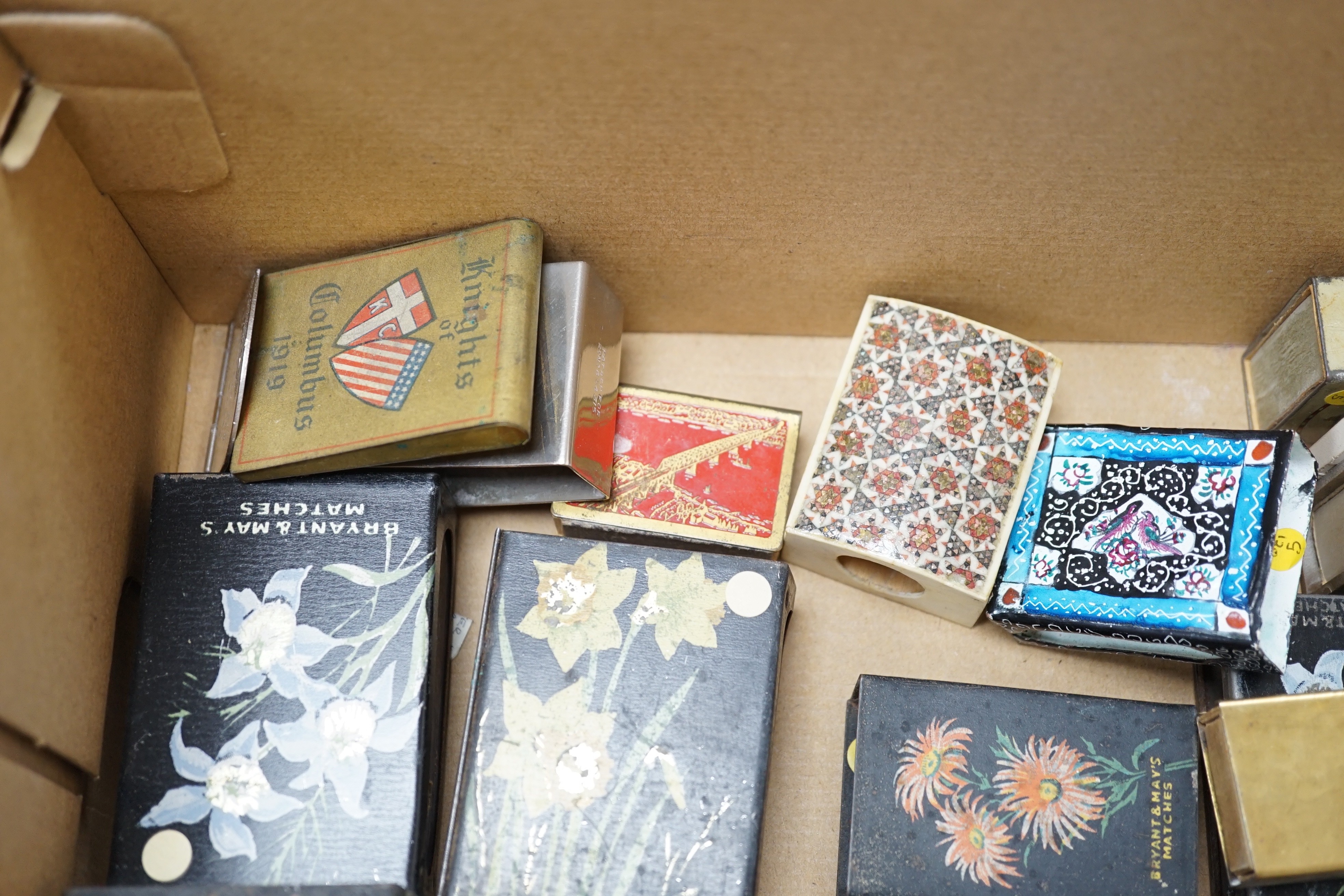 A collection of advertising and other enamelled metal match box holders